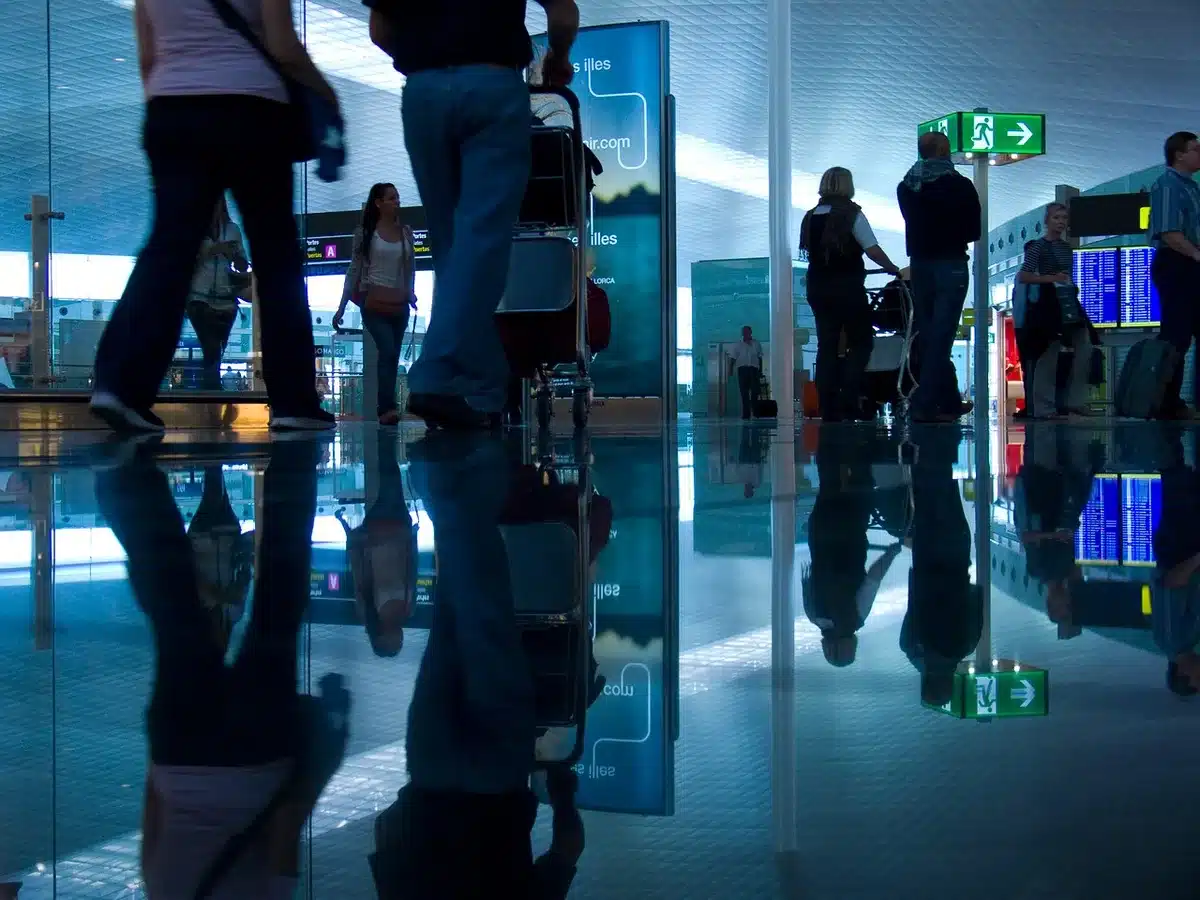 Interno del terminal con viaggiatori e cartelli generici